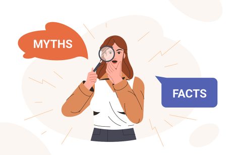 Woman looking through magnifying glass and comparing between myths and facts